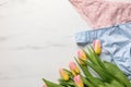 Elegant women\'s underwear and beautiful tulips on white marble background, flat lay. Space for text Royalty Free Stock Photo