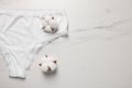 Elegant women's underwear and cotton flowers on white marble background, flat lay. Space for text Royalty Free Stock Photo