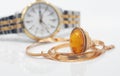 Elegant women's wristwatch, gold chain and large ring with amber