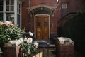 Elegant wooden front door surrounded by flowers, Holland. Royalty Free Stock Photo