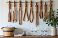 Elegant wooden kitchen utensils and cutlery on display with glassware in rustic interior Royalty Free Stock Photo
