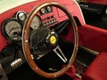 Elegant wooden steering wheel and vintage red dashboard of Vanderhall Venice Speedster, three-wheeled hand made autocycle. Royalty Free Stock Photo