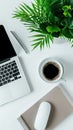 Elegant workspace featuring coffee, a notebook, and greenery in soft natural light