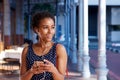 Elegant young black woman listening to music with smart phone Royalty Free Stock Photo