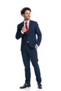 Elegant young businessman in navy blue suit looking to side and smiling Royalty Free Stock Photo