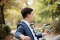 Elegant businessman using smartphone outdoors in the park Royalty Free Stock Photo