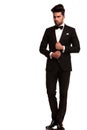 Elegant young fashion man adjusting his tuxedo Royalty Free Stock Photo