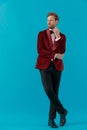 Elegant young fashion man wearing red velvet tuxedo Royalty Free Stock Photo