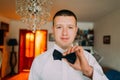 Elegant young fashion man in white shirt dressing bow-tie for marriage ceremony Royalty Free Stock Photo