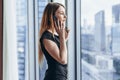 Elegant young female business owner holding documents talking on mobile phone discussing contract conditions standing in Royalty Free Stock Photo