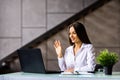 Elegant young woman business woman using a laptop sitting on a sofa at home Royalty Free Stock Photo