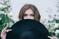 Ukrainian girl in a black dress outdoors in a hat