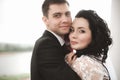 Elegant young happy wedding couple is sitting at green grass on Royalty Free Stock Photo