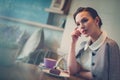 Elegant young lady alone in a cafe Royalty Free Stock Photo