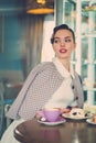 Elegant young lady alone in a cafe Royalty Free Stock Photo