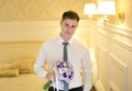 Elegant young man with a bouquet of flowers