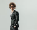 elegant young man with sunglasses holding hands in pockets and looking up Royalty Free Stock Photo