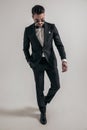 Elegant young man in tuxedo with hand in pocket looking down Royalty Free Stock Photo