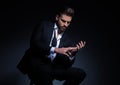 Elegant young man in tuxedo playing with his hands Royalty Free Stock Photo