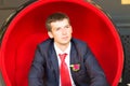 An elegant young man in tuxedo sitting, looking away from the camera Royalty Free Stock Photo