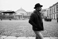 Elegant young man wearing hat walking in Piazza del Plebiscito in Naples, Italy