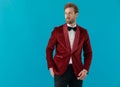 Elegant young man wearing red velvet tuxedo and looking to side Royalty Free Stock Photo