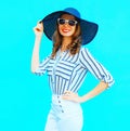 Elegant young smiling woman wearing a straw hat, white pants Royalty Free Stock Photo