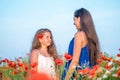 Elegant young woman with child girl in poppy field, happy family having fun in nature, summer time Royalty Free Stock Photo