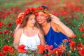 Elegant young woman with child girl in poppy field, happy family having fun in nature, summer time Royalty Free Stock Photo