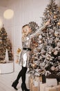 Elegant young woman in a  dress in the interior of a Christmas tree Royalty Free Stock Photo