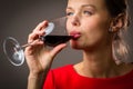 Elegant young woman having a glass of red wine Royalty Free Stock Photo