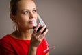 Elegant young woman having a glass of red wine Royalty Free Stock Photo