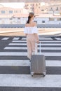 Elegant young woman with luggage at a train station. tourism concept Royalty Free Stock Photo