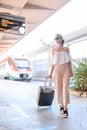 Elegant young woman with luggage at a train station. tourism concept Royalty Free Stock Photo