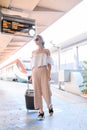 Elegant young woman with luggage at a train station. tourism concept Royalty Free Stock Photo