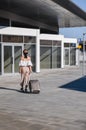Elegant young woman with luggage at a train station. tourism concept Royalty Free Stock Photo