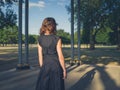 Elegant young woman in park at sunset Royalty Free Stock Photo