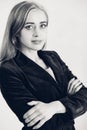 Elegant young woman posing leaning against a white wall. Woman in a classic jacket against a white wall Royalty Free Stock Photo