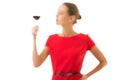 Elegant young woman in a red dress, having a glass of red wine Royalty Free Stock Photo