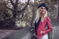 Elegant young woman standing on a stone parapet Royalty Free Stock Photo