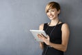 Elegant young woman using tablet leaning to wall Royalty Free Stock Photo