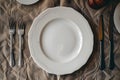 Elegant Table Setting with White Plate and Silver Cutlery for Formal Dining Generative AI Royalty Free Stock Photo