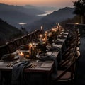 Elegantly decorated table and chairs overlooking the mountain ranges and the lake, candles lit on the table Royalty Free Stock Photo