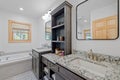 Elegantly designed bathroom interior featuring a large vanity, bathtub and sink Royalty Free Stock Photo