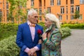 Elegantly dressed elderly couple walking outdoors