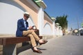 a guy in a business suit sitting on a bench and talking on the phone Royalty Free Stock Photo