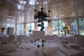 Elegantly served with wedding glasses, cutlery and decorated with flowers tables with white tablecloths and burning candles