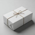 Elegantly wrapped gift box tied with a delicate golden ribbon on a neutral background Royalty Free Stock Photo