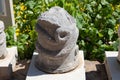 An element of an ancient stone column with the image of a snake