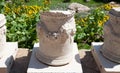 An element of an ancient stone column with a picture of fruits and ancient Greek inscriptions